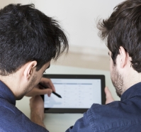 anonymous-man-discussing-data-tablet